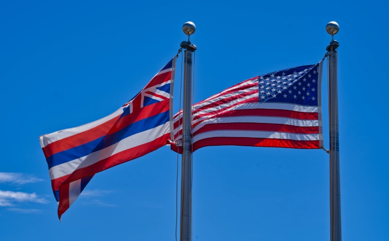 Flag of the State of Hawaiʻi next to the flag of the United States of America.