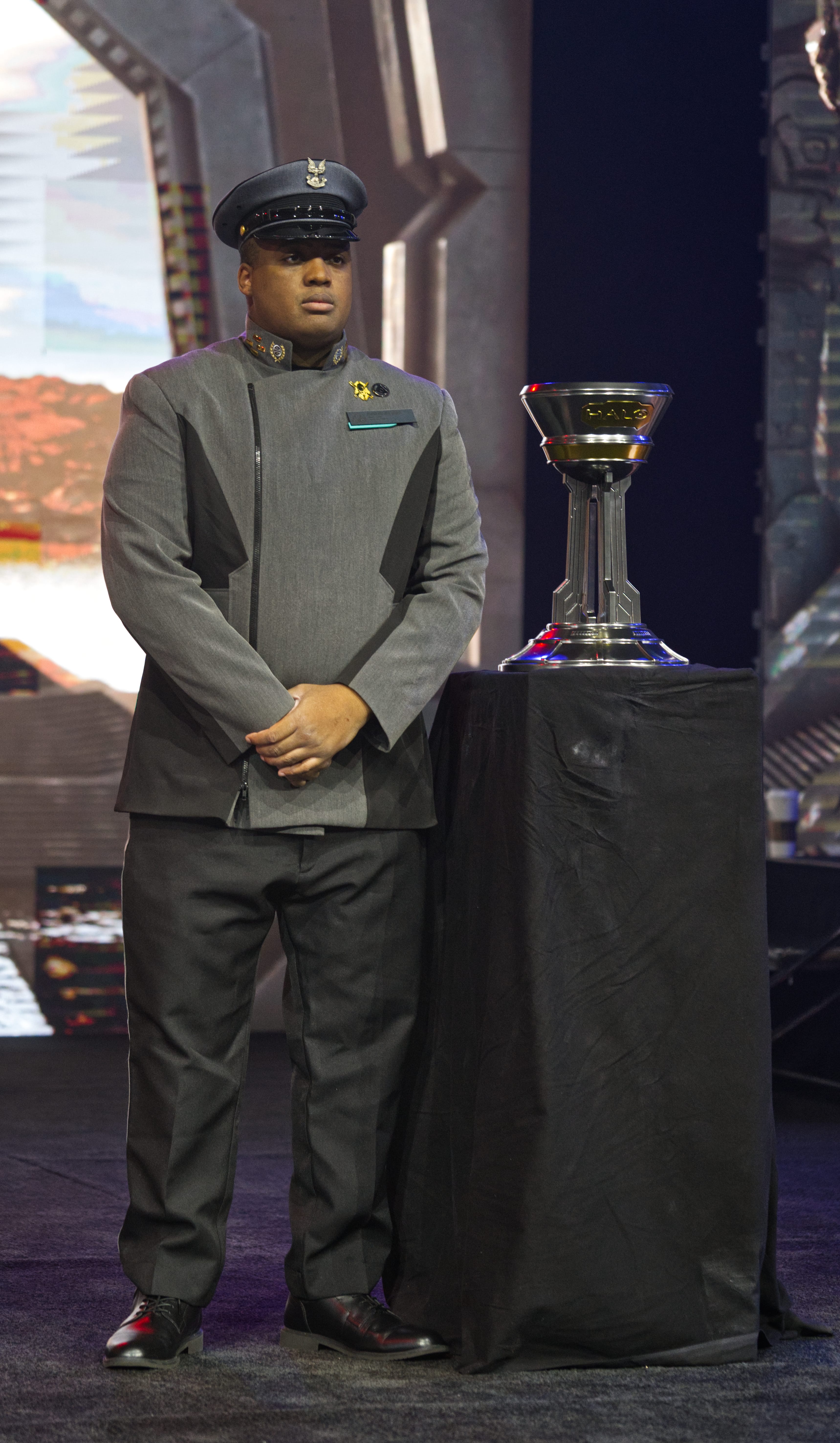 UNSC officer next to the Halo World Championship trophy.